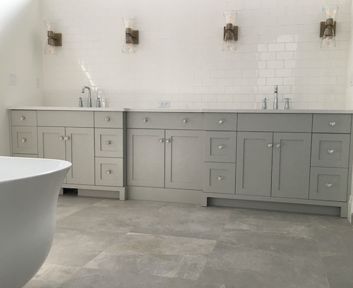 bathroom with white horizontal brick tiled walls and grey tiled floor